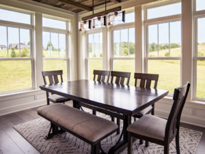 Dining room with fiberglass windows, dining room table, and rug.