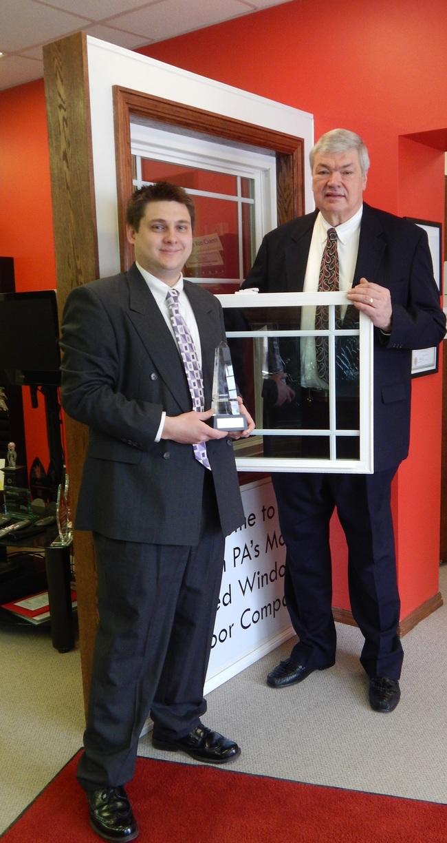 two men in suits winning award